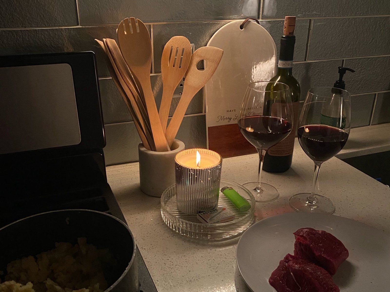A smiling couple cooking dinner together in their kitchen for a fun at-home date night
