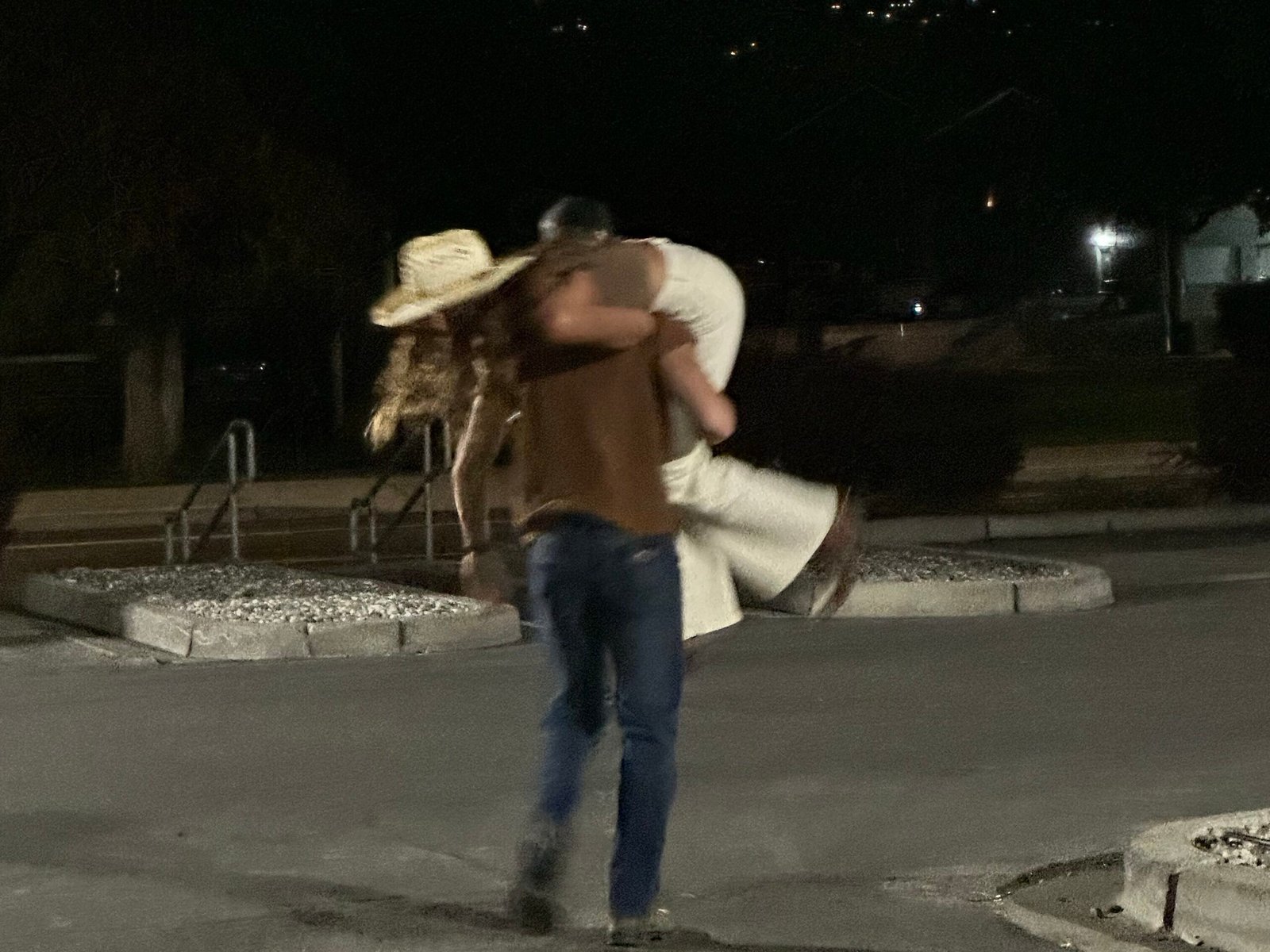 playful couple in parking lot having fun 